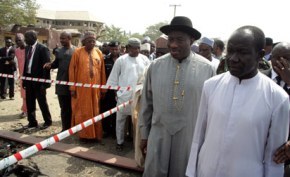 PRESIDENT GOODLUCK JONATHAN SHOWN AROUND THE SCENE OF A CHRISTMAS DAY BOMB ATTACK AT MADALLA, OUTSIDE THE CAPITAL ABUJA, WHERE 44 PEOPLE WERE KILLED.