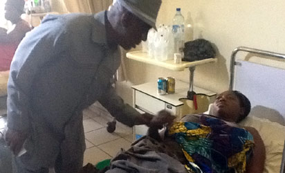EX-INTERIOR MINISTER, ABBA MORO WITH ONE OF THE INJURED VICTIMS AT THE NATIONAL HOSPITAL, ABUJA