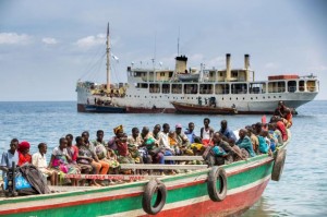 Refugees from Burundi who fled the ongoing violence and political tension sail on a boat to reach MV Liemba, a ship freighted by the United Nations at the Kagunga landing base on the shores of Lake Tanganyika near Kigoma in Tanzania, in this May 26, 2015 handout photo by PLAN INTERNATIONAL. East African leaders will meet on Sunday to discuss the crisis in Burundi as violent clashes between police and anti-government protesters continue and the opposition has boycotted talks to resolve the stand-off. REUTERS/Sala Lewis/PLAN INTERNATIONAL/Handout via Reuters