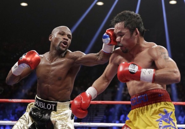 Floyd Mayweather Lands a Left Hook on Manny Pacquaio During Their Super- Fight in LA. 