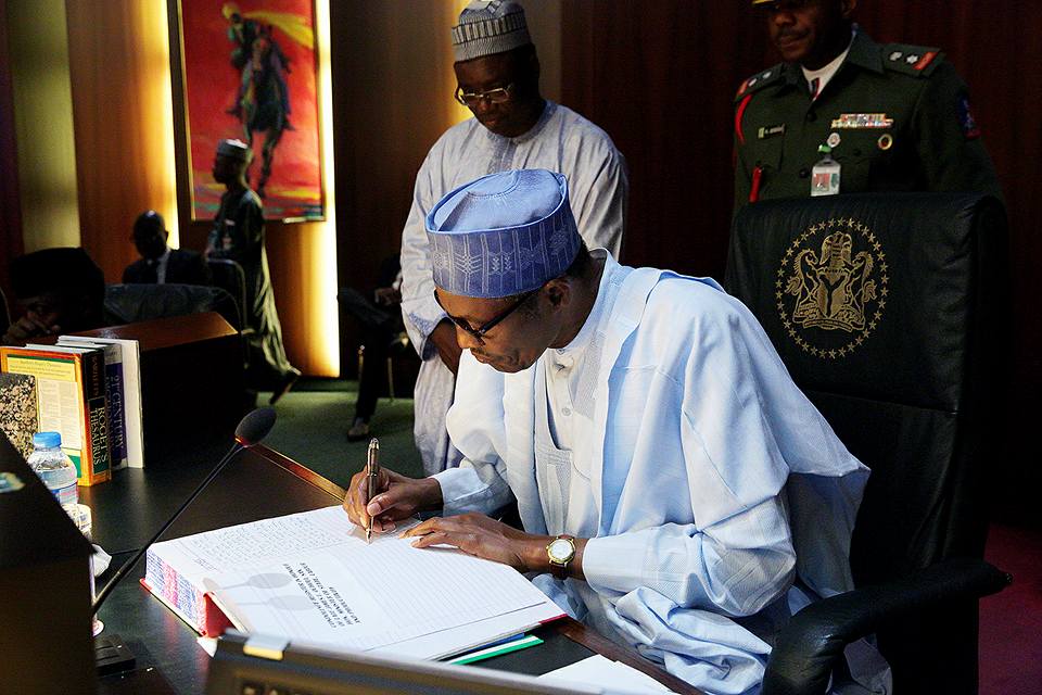 Image result for buhari signing papers