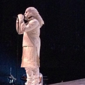 KANYE WEST IN FEATHERED MASK WHILE DRESSED IN ALL WHITE