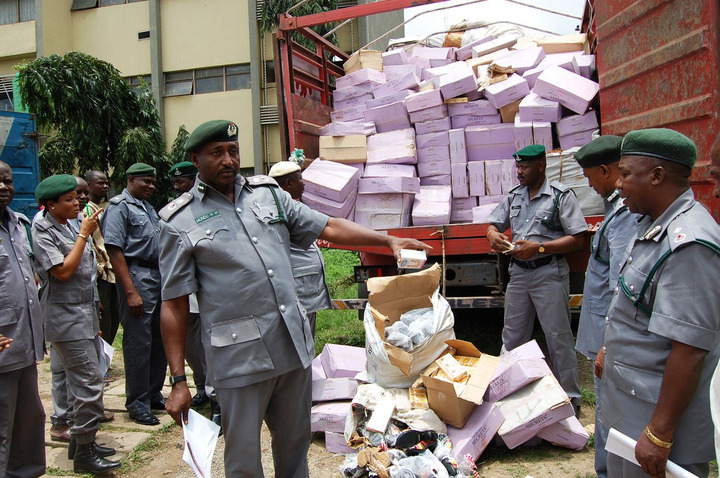 FILE: CUSTOMS OFFICIALS INSPECTING SOME IMPOUNDED GOODS