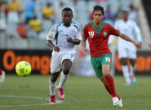 A Moroccan Player Vies for the Ball With Nigeria's Ejike Uzoenyi During the 2014 Africa Nations Championship (CHAN).