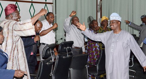 GOV. ABIOLA AJIMOBI (RIGHT) ACKNOWLEDGING CHEERS FROM LEADERS OF THE STATE NLC IN HIS OFFICE