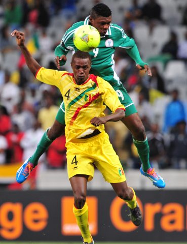 Gbolahan Salami Challenges for an Aeriel Ball Against a Malian Opponent During a 2014 CHAN Group Game. 