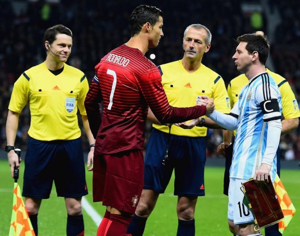 Lionel Messi and Cristiano Ronaldo, Captains of Argentina and Portugal Respectively, During The Pre-Game Formalities at Old Trafford. Image: Getty.