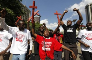 Protesters chant slogans as they carry wooden crosses during the #OccupyHarambeeAve protest in Nairobi