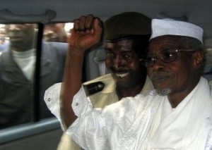 Former Chad President Habre raises his fist in air as he leaves court in Dakar, Senegal
