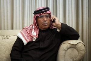 Safi al-Kasaesbeh, father of Jordanian pilot Muath, speaks on a telephone as he follows the news of his son in Amman