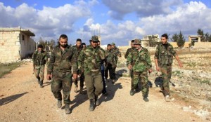 Forces loyal to Syria's President Bashar al-Assad walk in al-Mallah Farms after regaining control of the area in north of Aleppo