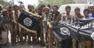 Army soldiers display flags of the al Qaeda-linked Ansar al-Sharia group, at a position recaptured from thr group near the southern Yemeni city of Zinjibar
