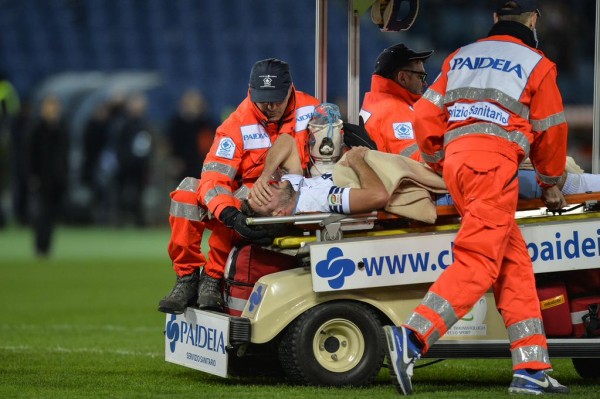Serb Filip Djordjevic Wheeled Off the Pitch After Fracturing His Ankle Against AC Milan. Image: Getty.