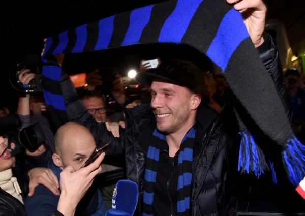 Lukas Podolski Hoisting an Inter Scarf at Linate Airport as His Arsenal Departure Nears. Image: Inter.it.