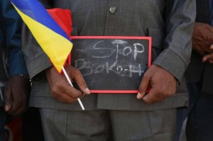A man holds a sign that reads "Stop Boko Haram" at a rally to support Chadian troops heading to Cameroon to fight Boko Haram in Ndjamena