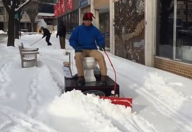 See Man Plowing Snow With Motorized Toilet.