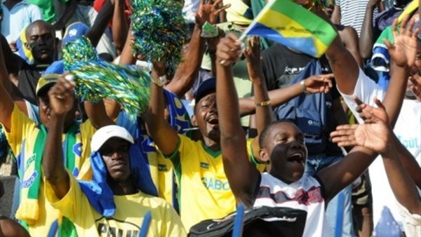 Gabon Fans Wave Flags and Pom Pom During a Football Game Against Morocco. Image: Getty.