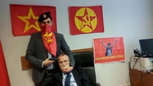 A gunman poses with Prosecutor Mehmet Selim Kiraz with a gun on his head after he was taken hostage in his office in a court house in Istanbul
