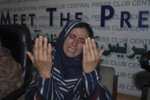 Bibi, sister of Hussain who was charged as a child with murder and due to be hanged, reacts during a news conference with other family members in Muzaffarabad