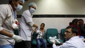 Doctors attend to a boy who was injured during an earthquake, at a trauma center in Kathmandu