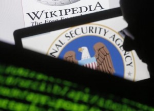 A man is seen near cyber code and the U.S. National Security Agency logo in this photo illustration taken in Sarajevo March 11, 2015. REUTERS/Dado Ruvic