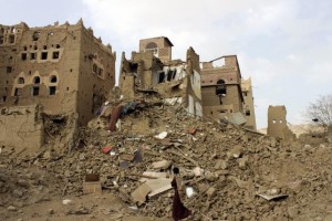 A man walks past houses damaged by Saudi-led airstrikes in Yemen's northwestern city of Saada May 26, 2015. Picture taken May 26, 2015. REUTERS/Stringer