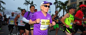 In this photo provided by Competitor Group, Harriette Thompson starts the Suja Rock n Roll Marathon in San Diego on Sunday, May 31, 2015. Thompson, of Charlotte, N.C., is a two-time cancer survivor who dealt with the loss of her husband and a staph infection in her legs while training for this years race. If she completes the race she would become, at age 92 years and 65 days, the oldest woman to ever complete a marathon. Her son Brenny Thompson is behind her in the purple shirt. (Paul Nestor/Competitor Group via AP)