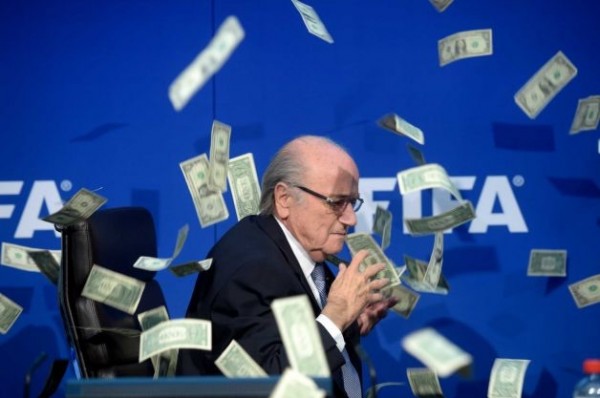 Blatter Ducks as Lee Nelson's Fake Dollar Bills Rain on Stage. 
