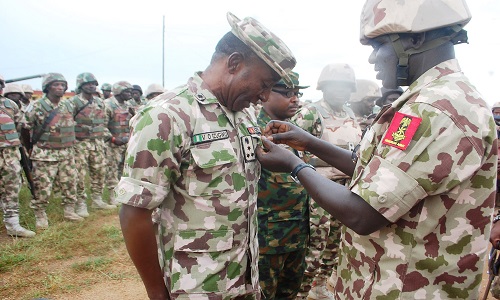 PIC. 9. THE CHIEF OF ARMY STAFF, LT.-GEN. TUKUR BURUTAI (R), DECORATING WITH A MEDAL, BRIG.-GEN. VICTOR EZUGWU, THE COMMANDER, OF THE 28 TASK FORCE BRIGADE FIGHTING INSURGENTS, DURING THE CHIEF OF ARMY STAFFS VISIT TO MUBI IN ADAMAWA ON WEDNESDAY 