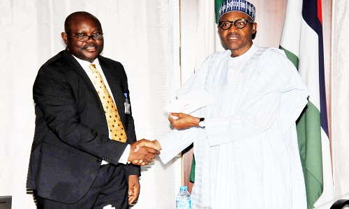 PIC. 24. PRESIDENT MUHAMMADU BUHARI (R), RECEIVING HIS NATIONAL IDENTITY CARD FROM THE DIRECTOR-GENERAL, NATIONAL IDENTITY MANAGEMENT COMMISSION (NIMC), MR CHRIS ONYEMENAM, AT THE PRESIDENTIAL VILLA IN ABUJA ON WEDNESDAY (14/10/15). 7258/14/10/2015/ICE/CH/BJO/NAN