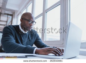 stock-photo-image-of-african-american-businessman-working-on-his-laptop-handsome-young-man-at-his-desk-262840061