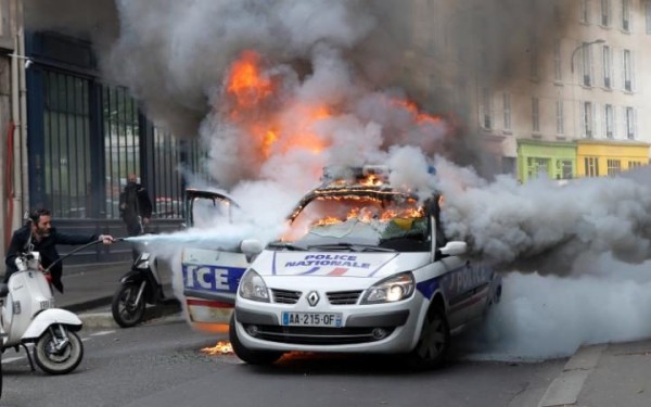 Protesters torched a police car on Wednesday
