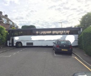 Charter-bus-attempting-a-three-point-turn-gets-wedged-across-road