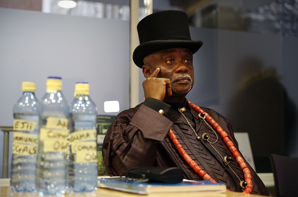 Bottled water samples stand on a table as Nigerian tribal king Emere Godwin Bebe Okpabi speaks during an interview in central London on November 21, 2016. Britain's High Court will on November 22, begin to hear arguments on whether the English Courts can hear two legal claims on behalf of over 40,000 Nigerians against Royal Dutch Shell and its Nigerian subsidiary, Shell Petroleum Development Company of Nigeria (SPDC), in relation to environmental damage caused to two separate communities in the Niger Delta. / AFP / ADRIAN DENNIS / TO GO WITH AFP STORY by Alice RITCHIE (Photo credit should read ADRIAN DENNIS/AFP/Getty Images)