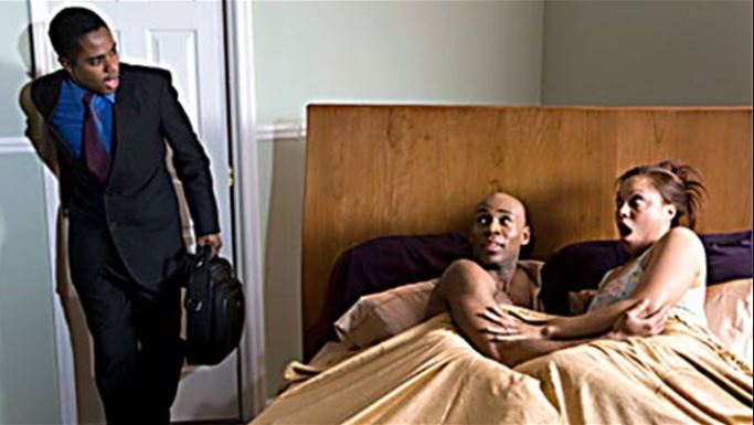 File photo of a man walking in on his wife with another man in bed 