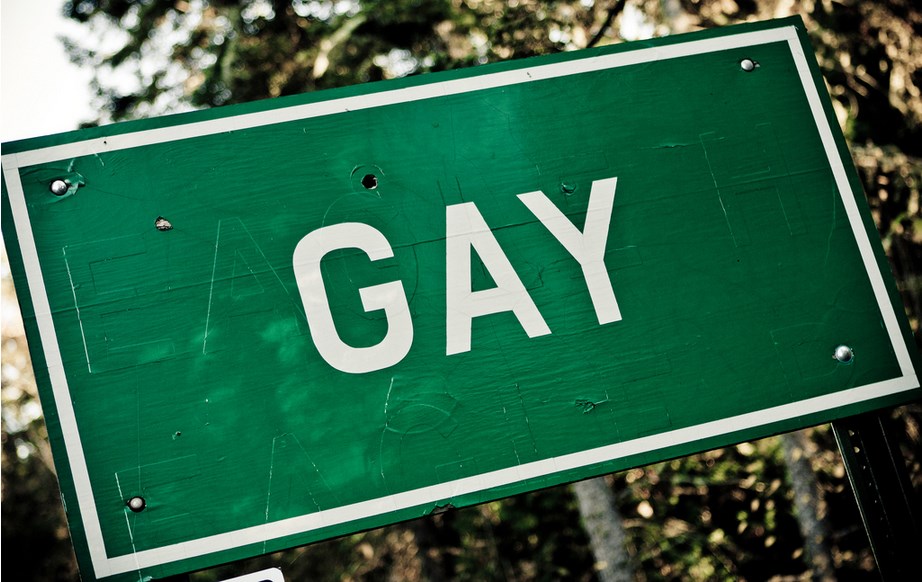 A sign with the letters spelling GAY