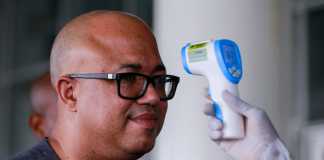 Dr. Chikwe Ihekweazu, the Director General of the Nigeria Centre for Disease Control (NCDC) has his temperature checked during a diplomatic meeting at the Ministry of Foreign Affairs in Abuja, Nigeria March 12, 2020. REUTERS/Afolabi Sotunde